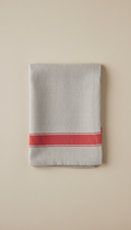 Metro red accent linen napkin, Three-quarter angle product shots on uncluttered matte neutral surfaces (Soft Stone or...