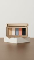 Luxury pressed eyeshadow palette, Three-quarter hero angle for product focus—elevated on a sculptural plinth against a...