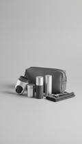 Photograph a travel grooming kit centered on the frame with a soft gray background. Use soft, even illumination to...