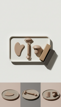 Expert facial tool set with matte ceramic tray, 3/4 angle product shots on matte stone or ceramic platters against...