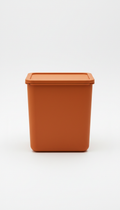 A compact storage bin in Sunset Orange, the image is framed straight-on to emphasize elegance and clarity. No logos, no...